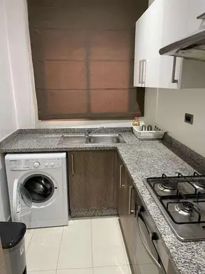 a kitchen with a sink and a washing machine at Le villagois in Marrakech