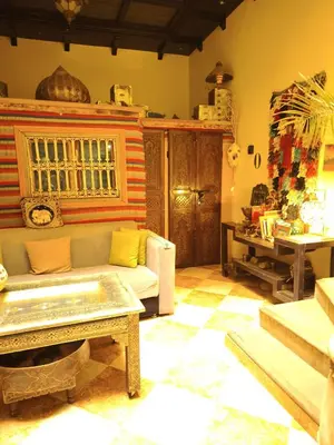 a living room with a couch and a table at maison Noé , chambre au rez de chaussée ,un lit double, sale de bain privative séparer in Marrakech