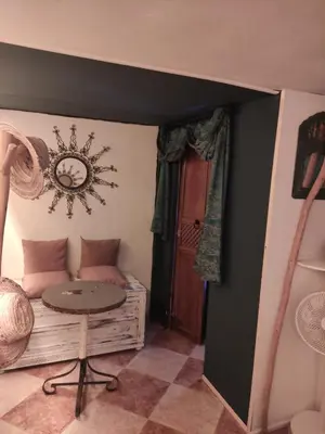 a room with a bed and a table in it at maison Noé , chambre au rez de chaussée ,un lit double, sale de bain privative séparer in Marrakech