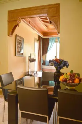 a room with a table with a bowl of fruit on it at Palmeraie Stay - Pool & Lake in Marrakech