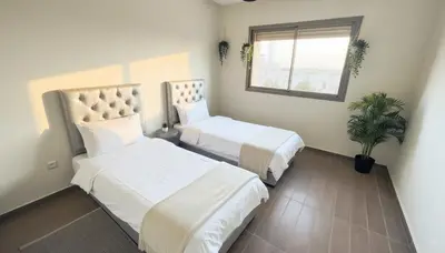 a hotel room with two beds and a window at Central Cozy Kesh - Pool - Terrace in Marrakech