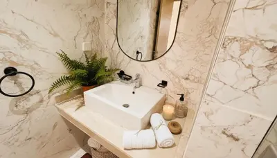 a white bathroom with a sink and a mirror at Central Cozy Kesh - Pool - Terrace in Marrakech