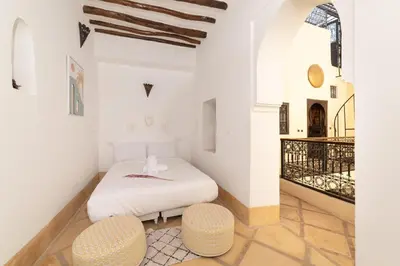 a bedroom with a bed and two chairs at Riad Privé Dar El Khamsa-Petit Dej inclus in Marrakech