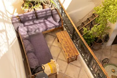 an overhead view of a living room with a couch and a table at Riad Privé Dar El Khamsa-Petit Dej inclus in Marrakech