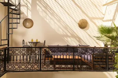 a balcony with a couch in a room at Riad Privé Dar El Khamsa-Petit Dej inclus in Marrakech