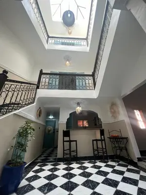 a room with a checkered floor and a ceiling at RIAD Al QARYA 4 chambres in Marrakech