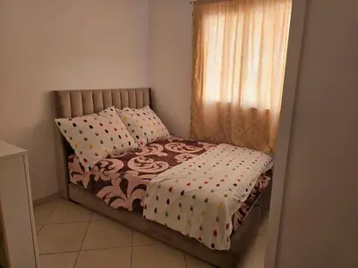 a small bed in a room with a window at Appartement Meublé 2 Chambres avec Wi-Fi Haut Débit in Marrakech