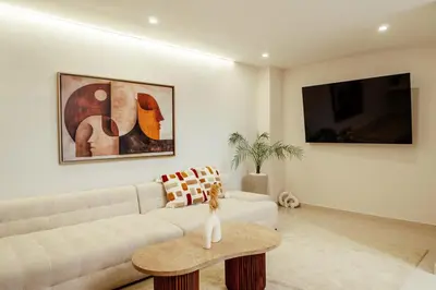 a living room with a couch and a table at Luxury 4 bed apartment In the heart of Guilez! in Marrakech