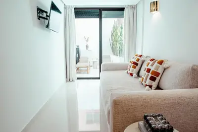 a white living room with a couch and a window at Luxury 4 bed apartment In the heart of Guilez! in Marrakech