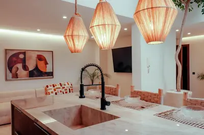 a kitchen with a sink and chandeliers at Luxury 4 bed apartment In the heart of Guilez! in Marrakech