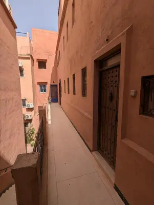 an empty alley with a door in an old building at Duplex Marakech Dotea Lilia in Marrakech