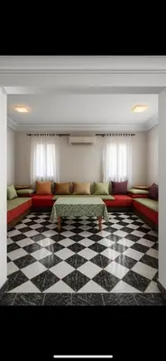a living room with couches and a checkered floor at Duplex Marakech Dotea Lilia in Marrakech