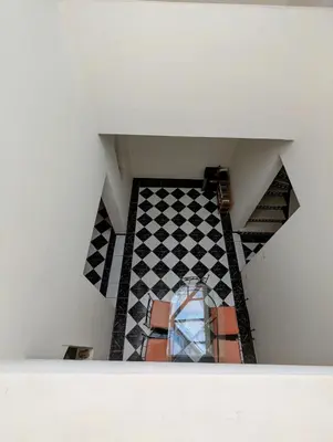an attic view of a room with a checkered floor at Duplex Marakech Dotea Lilia in Marrakech