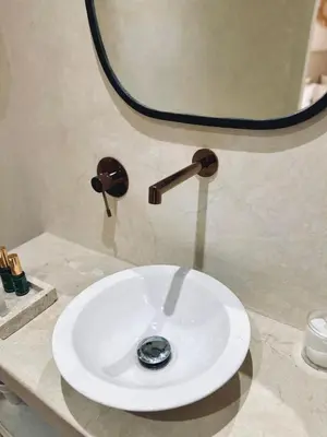 a white sink in a bathroom with a mirror at Riad Baba in Marrakech
