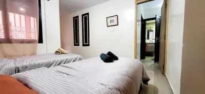 a room with two beds and a hallway at Cozy Duplex in downtown Marrakesh- 7mn from Gueliz in Marrakech