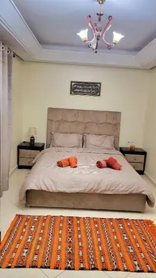 a bedroom with a large bed with two pillows on it at Cozy Duplex in downtown Marrakesh- 7mn from Gueliz in Marrakech