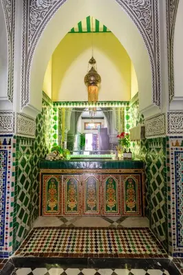 an ornate room with a wooden table in a building at L Mansion Villa in Najem