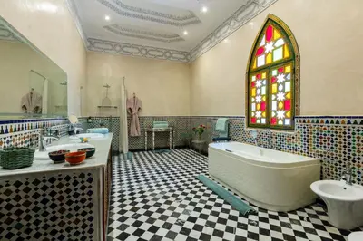 a bathroom with two sinks and a tub and a window at L Mansion Villa in Najem