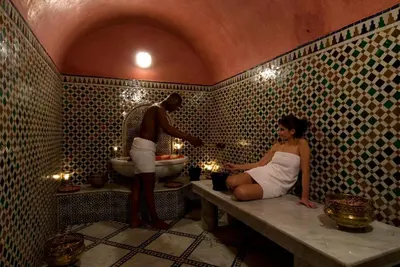 a man giving a woman a sink in a bathroom at L Mansion Villa in Najem