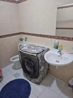 a bathroom with a toilet and a sink and a tv at Machaalah gueliz in Marrakech