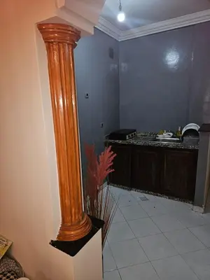 a large wooden column in a room with a kitchen at Machaalah gueliz in Marrakech