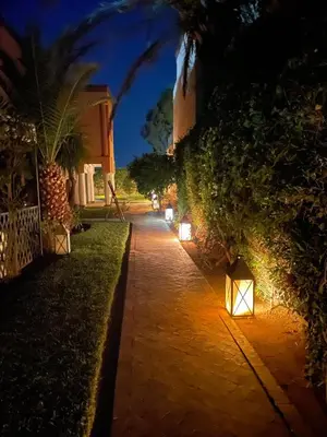 a walkway with lights on it at night at Casa Zitouni - Oasis with pool & private staff in Marrakech