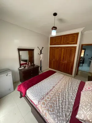 a bedroom with a bed and a dresser and a mirror at Spacious 2 bedroom apartment 6 people 5 min from Marrakech center in Marrakech