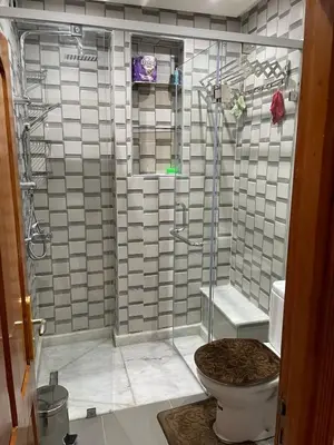 a bathroom with a shower with a toilet at Spacious 2 bedroom apartment 6 people 5 min from Marrakech center in Marrakech