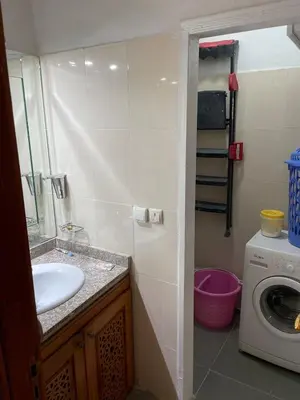 a bathroom with a sink and a washing machine at Spacious 2 bedroom apartment 6 people 5 min from Marrakech center in Marrakech