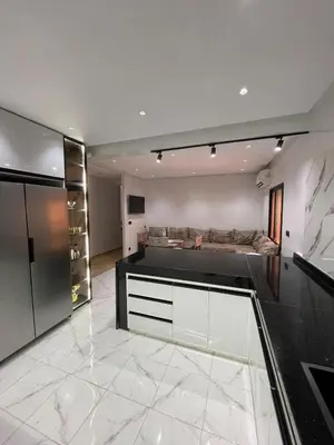 a large living room with a couch in the background at Spacious 2 bedroom apartment 6 people 5 min from Marrakech center in Marrakech