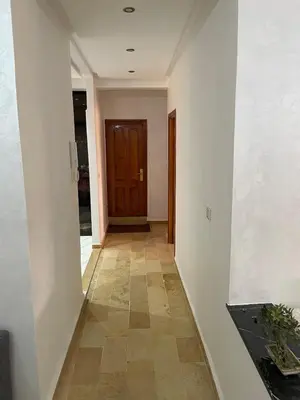a hallway with a door and a tile floor at Spacious 2 bedroom apartment 6 people 5 min from Marrakech center in Marrakech
