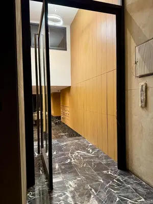 an empty hallway in a building with a glass door at Marrakech Elite Garden, moderne, chaleureux, tout équipé in Marrakech