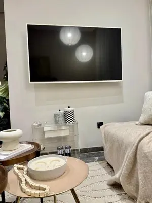 a living room with a flat screen tv on the wall at Marrakech Elite Garden, moderne, chaleureux, tout équipé in Marrakech