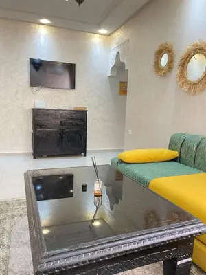 a living room with a fish tank and a couch at lUXEE APPARTEMENTN BELLE in Marrakech