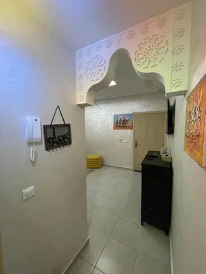 a hallway with a room with a desk and an arch at lUXEE APPARTEMENTN BELLE in Marrakech