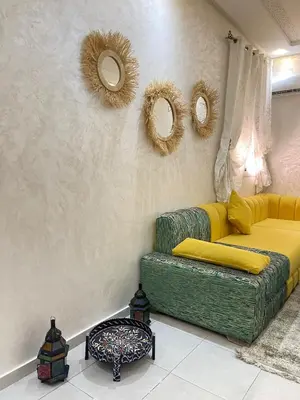 a living room with a couch and mirrors on the wall at lUXEE APPARTEMENTN BELLE in Marrakech