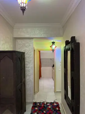 a room with a hallway with a mirror and a light at lUXEE APPARTEMENTN BELLE in Marrakech