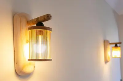 a light on a wall with a wooden stick on it at Luxury apartment with pool in Marrakech