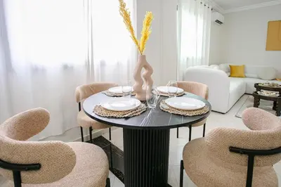 a dining room with a table and chairs at Luxury apartment with pool in Marrakech