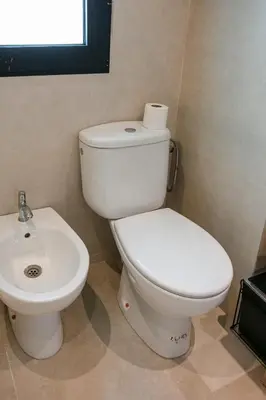 a white toilet and a sink in a bathroom at Luxury apartment with pool in Marrakech