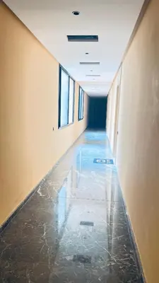 an empty hallway with water on the floor of a building at Luxury apartment 2 min Train Station 10 min Airport in Marrakech