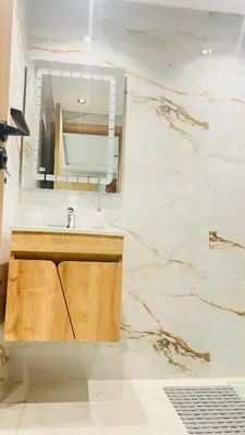 a bathroom with a sink and a mirror at Luxury apartment 2 min Train Station 10 min Airport in Marrakech