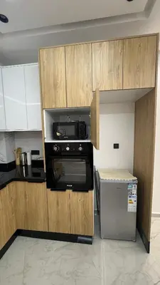 a kitchen with a microwave and a refrigerator at Luxury apartment 2 min Train Station 10 min Airport in Marrakech