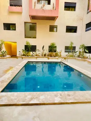 a swimming pool in front of a building at Luxury apartment 2 min Train Station 10 min Airport in Marrakech