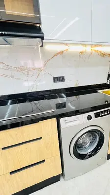 a kitchen with a washing machine and a counter at Luxury apartment 2 min Train Station 10 min Airport in Marrakech