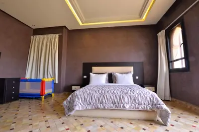 a bedroom with a large bed with a coffered ceiling at Luxury Villa in Marrakech