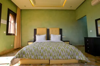 a bedroom with a large bed with green walls at Luxury Villa in Marrakech