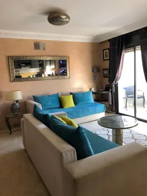 a living room with a couch and a table at Bel appartement central in Marrakech