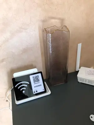 a table with a tablet and a vase on it at Bel appartement central in Marrakech