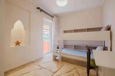 a childs bedroom with a bunk bed and a window at Confort Spacieux a Hivernage 3 Chambres and Piscine in Marrakech